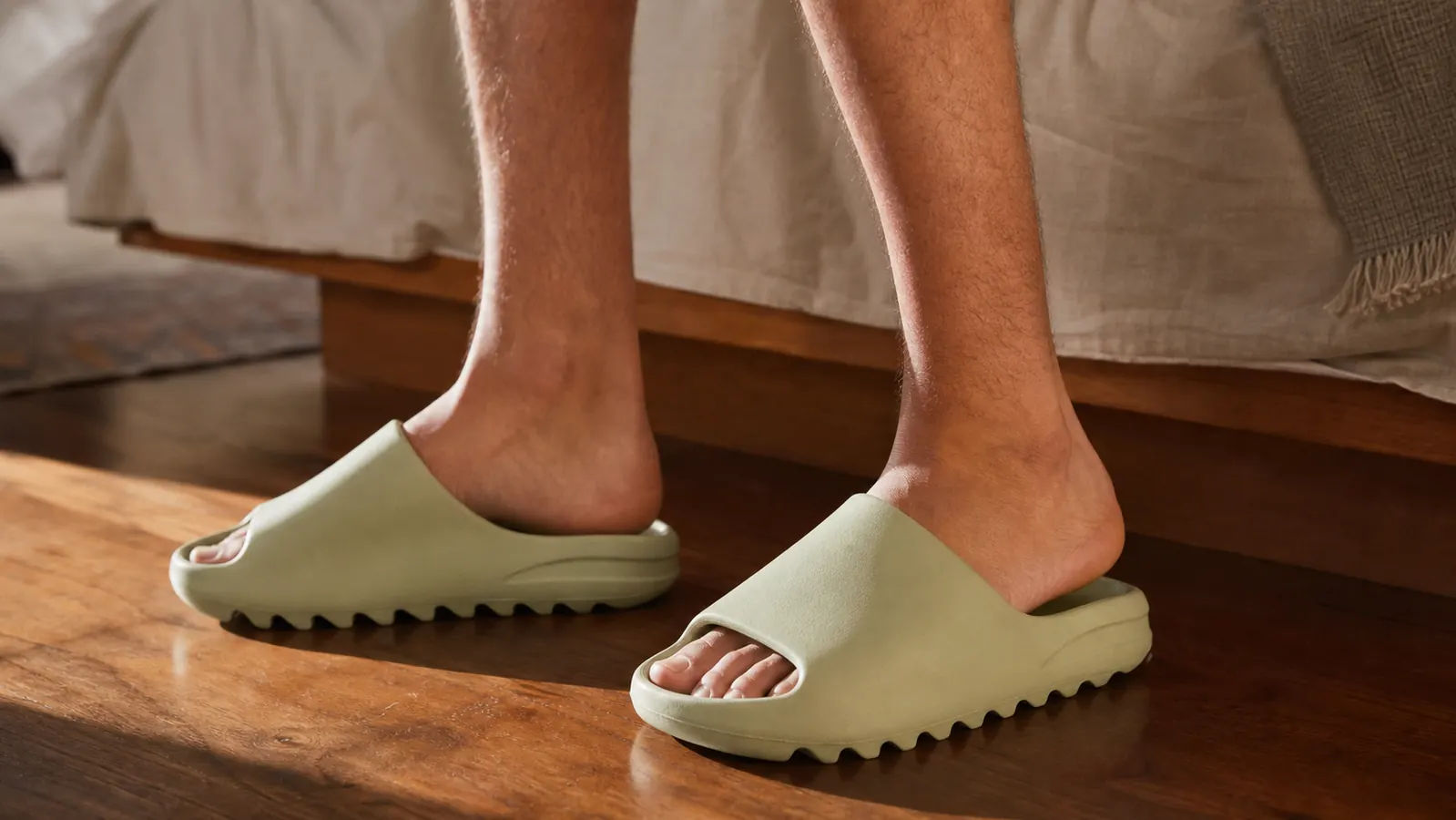Athlete wearing OOFOS slides walking poolside after a swim workout
