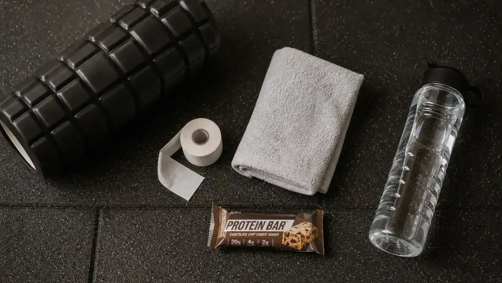TriggerPoint GRID 2.0 foam roller on a gym floor next to a water bottle and training shoes